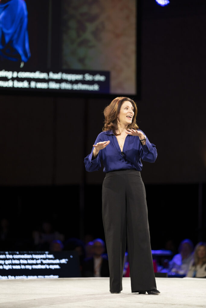 Female executive speaking on stage during a keynote session at the WBENC National Conference in Denver, captured by a corporate event photographer.