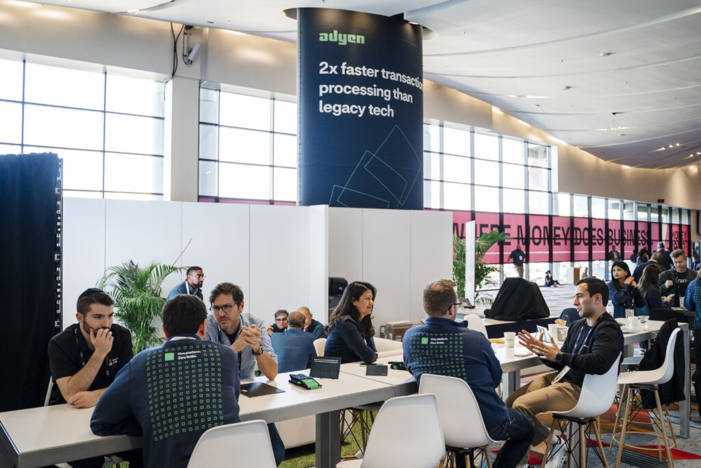 Professional one-on-one meetings inside a Las Vegas exhibit booth as attendees discuss products and services.