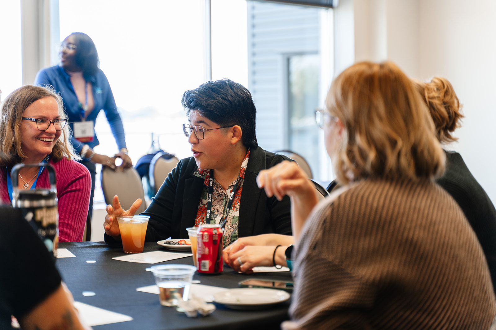 Association members participate in a small-group discussion during a women-focused networking session, showcasing peer connection and collaborative learning.
