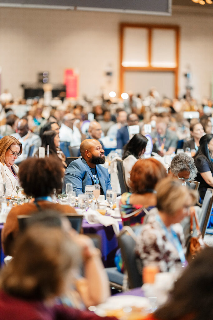 Candid photography of attendees engaged during breakout sessions. 