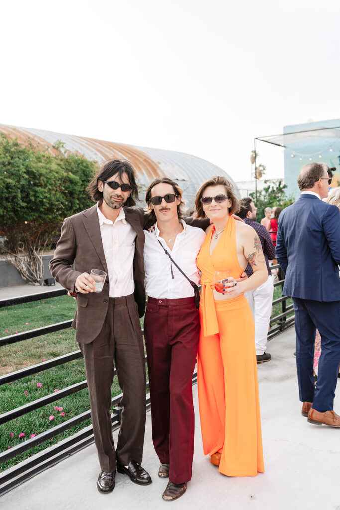 Stylish wedding guests enjoying cocktail hour at an outdoor large scale wedding celebration photographed by a Las Vegas destination wedding photographer