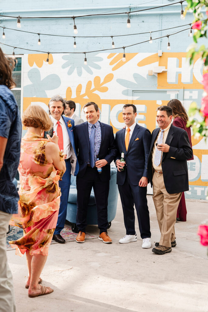 Wedding guests laughing and celebrating during a high energy cocktail hour at a large wedding photographed by a Las Vegas large scale wedding photographer