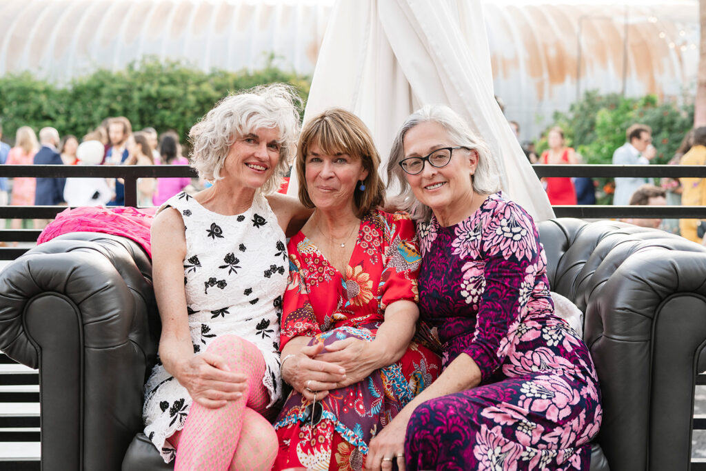 
Joyful family group photo during wedding cocktail hour at an outdoor venue photographed by a large scale wedding photographer based in Las Vegas