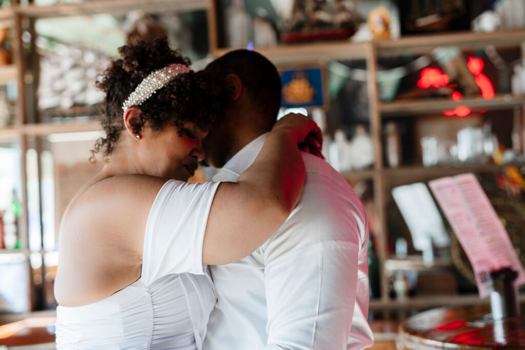Elopement celebration at Davy’s Locker with the couple dancing privately in a relaxed bar setting, highlighting how elopements prioritize meaningful moments over formal wedding structure.
