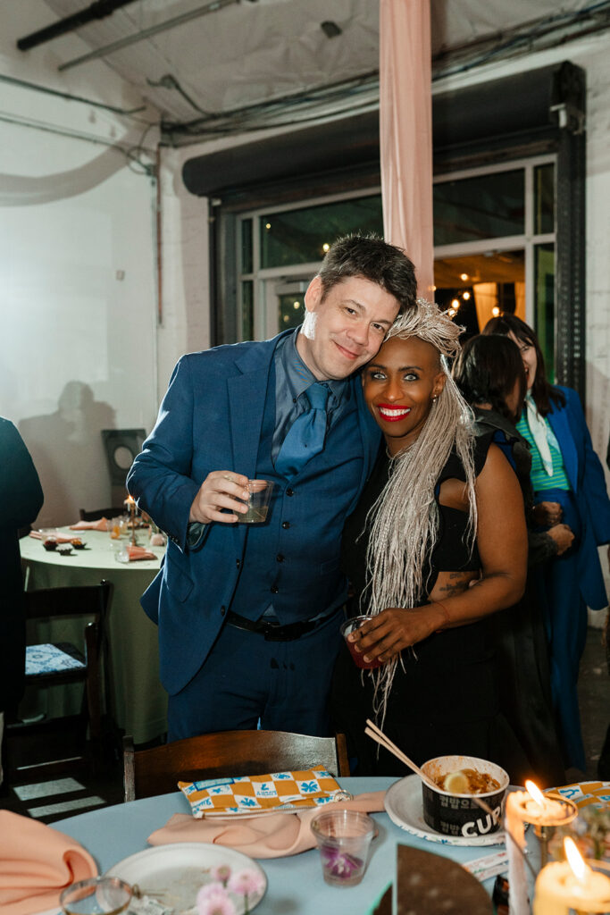 Two wedding guests sharing a warm moment together during a large scale wedding reception photographed by True Colors Team Las Vegas wedding photographers