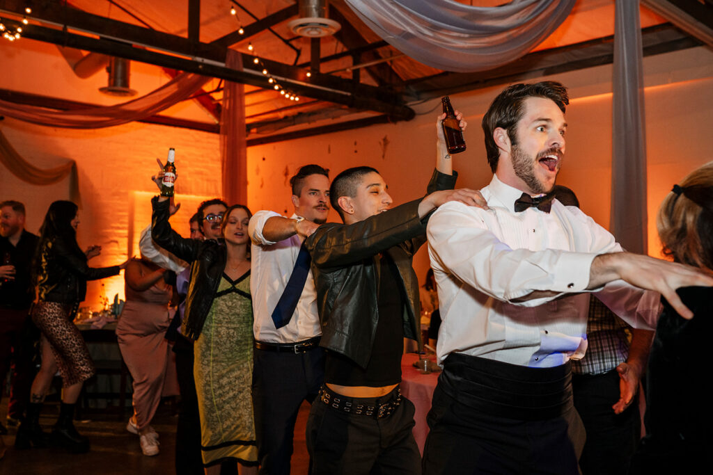 edding guest caught in a genuine candid moment on a high energy dance floor at a large scale wedding celebration photographed by True Colors Team Las Vegas wedding photographers