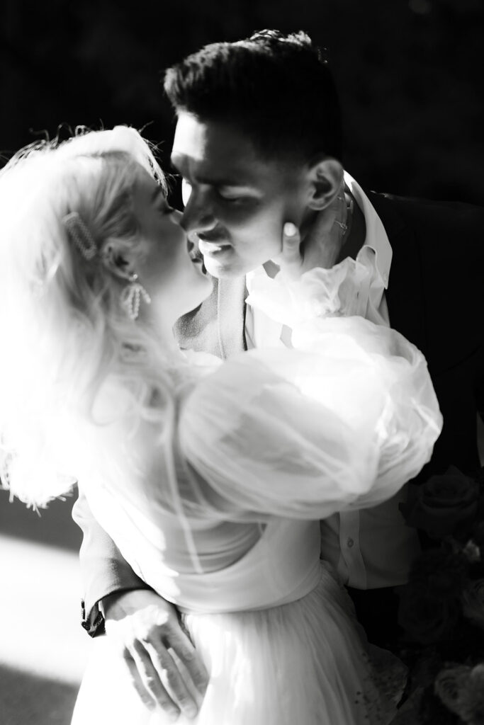Intimate black and white wedding portrait of bride and groom captured by a destination wedding photographer in Northern California
